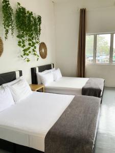Ένα ή περισσότερα κρεβάτια σε δωμάτιο στο Motel Pantai Cahaya
