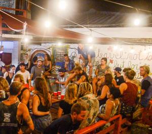 a large group of people sitting in a room at Hola Ola Hostel in San Juan del Sur