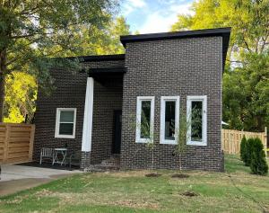 a small brick house with white windows on it at Perfectly located 2 bed/2 full bathroom/1 sofa bed in Bentonville