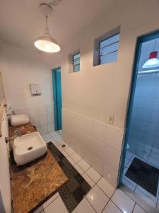 a bathroom with a toilet and a glass shower at Nomad Hostel - Vila Madalena in São Paulo