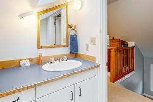 a bathroom with a sink and a mirror at Big Blue in Neskowin +20 photos