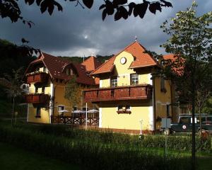 a large yellow house with a red roof at Hotel Szeleta in Lillafüred