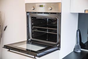 an oven with its door open in a kitchen at Comfort Apartment Oldenburg in Oldenburg