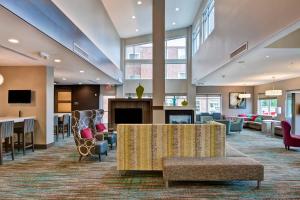 a large lobby with a waiting area and a fireplace at Residence Inn by Marriott Milwaukee North/Glendale in Glendale