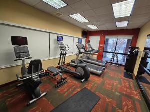 a gym with several treadmills and cardio machines at Country Inn & Suites by Radisson, Convention Center in Altoona