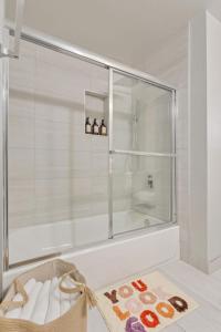 a bathroom with a shower with a glass door at Our West Nest, Charming 3 BR-5 Bed - Backyard - Olde Town Arvada in Arvada