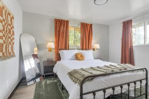 a bedroom with a bed and a mirror at Our West Nest, Charming 3 BR-5 Bed - Backyard - Olde Town Arvada in Arvada