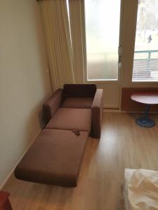 a living room with a couch and a window at Apartment 137 in Ikaalinen Spa-Hotel, 1st floor in Ikaalinen +7 photos