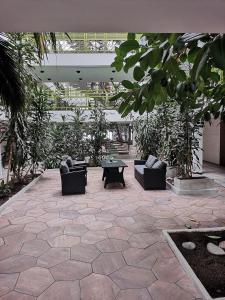 a courtyard with couches and plants in a building at Apartment 137 in Ikaalinen Spa-Hotel, 1st floor in Ikaalinen