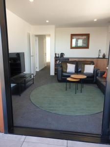 a living room with a couch and a table at Mathea House in Richmond