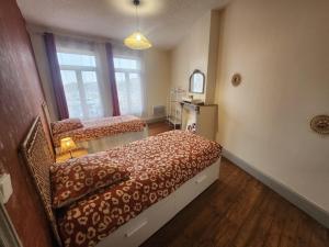 a small bedroom with two beds and a window at L 'Échappée Cambrésienne in Cambrai +5 photos