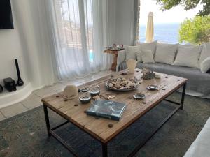un soggiorno con un tavolo e un divano di Waterfront Luxurious Villa - Kea Island a Melissaki