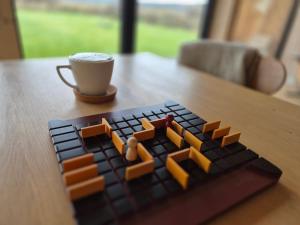 a lego keyboard with a cup of coffee on a table at Morze Dębina in Debina +51 photos