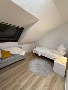 a living room with two beds and a tv at Apartment in Gernsbach in Gernsbach +23 photos