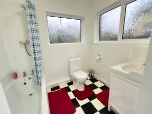 a bathroom with a toilet and a tub and a sink at Large double room in Portsmouth - Mayhall Rd in Portsmouth