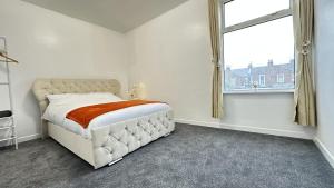 a white bedroom with a bed and a window at Large double room in Portsmouth - Mayhall Rd in Portsmouth