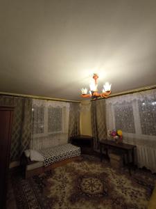 a room with a bed and a chandelier and a ceiling at Valda House in Rybie +62 photos