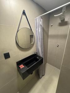 a bathroom with a sink and a mirror at Hotel Pousada Villa Marina in Fortaleza +24 photos