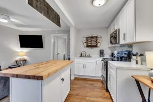 a kitchen with white cabinets and a wooden counter top at Pasture Bedtime in Franklin