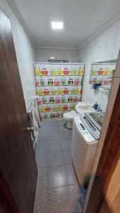 a bathroom with a toilet and a sink at Casa Equipada Piscina Quincho Refugio Los Cerezos in Estación Cuñibal