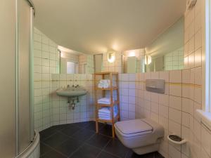 a bathroom with a toilet and a sink at Villa Taube in Bad Gastein +43 photos