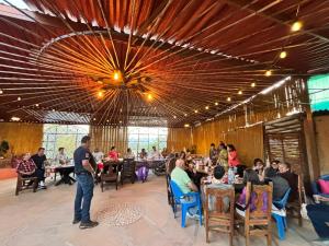a group of people sitting at tables in a restaurant at Hotel SPA Campestre Los Adobes in Taxco de Alarcón +50 photos
