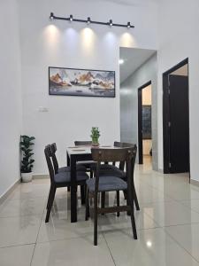 a dining room with a table and chairs at V-Home Taiping, 3BR, 7pax, Full Aircond, Wifi & Netflix, Early Bird Promo in Taiping