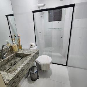 a bathroom with a marble sink and a shower at Apartamento 3 da Cíntia in Lençóis