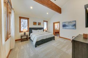 a bedroom with a bed and a television in it at Ski-InandSki-Out Schweitzer Mtn Home Decks and Views! in Sandpoint