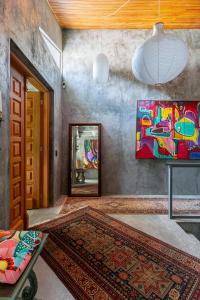 a living room with a painting on the wall at Emerald House in Rio de Janeiro