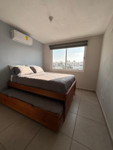 a bedroom with a large bed and a window at New Modern Acapulco Diamante House Getaway with Pool View and Beach Club in Acapulco +48 photos