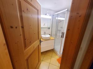 a bathroom with a sink and a shower at Single room in nice house in Klosters Dorf