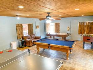 a living room with a pool table and a couch at Waterfront Teepee 2 Red Fox in Seguin