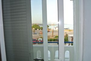 a window with a view of a parking lot at Kokalakis Hotel in Kefalos