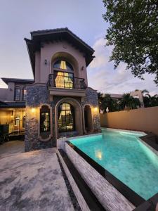 a house with a swimming pool in front of it at T1-Tuscany Private Pool Villa-บางแสน in Ban Hua Khao Sammuk