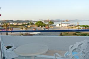 a balcony with a table and a view of a street at Kokalakis Hotel in Kefalos