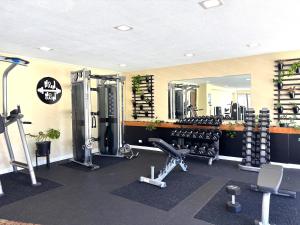 a gym with dumbbells and weights and a mirror at Royal Kuhio 1705 - Spacious Corner Unit with Stunning Mountain Views in the Heart of Waikiki! in Honolulu