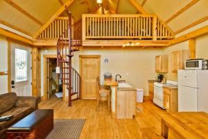 een keuken en een woonkamer met een trap in een huisje bij Treehouse 3 - Mourning Dove Haus in New Braunfels