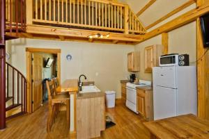 een keuken met een witte koelkast en een magnetron bij Treehouse 3 - Mourning Dove Haus in New Braunfels