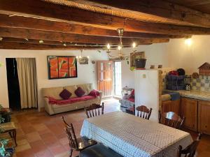 a living room with a table and a couch at Ventana Al Desierto in Real de Catorce