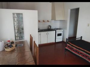 a kitchen with a sink and a stove top oven at Depto en Concordia in Concordia
