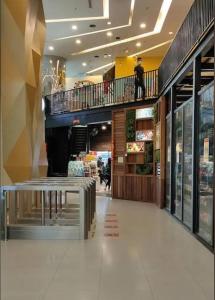 a person standing on the second floor of a shopping mall at SP Home At Mercu Summer Suites in Kuala Lumpur +77 photos