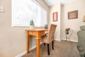 a wooden desk in a room with a window at Longer Stays for Travelers- Apt Blocks from Hospital, Downtown in Visalia +45 photos
