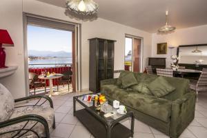 a living room with a green couch and a table at Hotel le Dauphin in Ajaccio