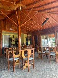 a dining room with wooden tables and chairs at POUSADA FAZENDA PAIM in São José dos Ausentes