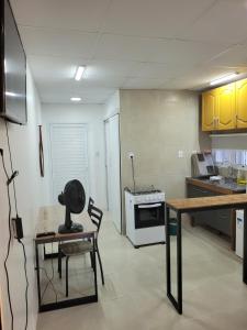 a kitchen with a table and chairs in a room at studio Aconchegante two in Santa Maria
