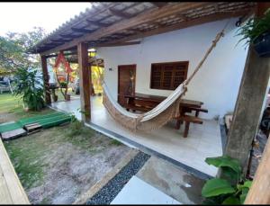 a hammock hanging from the side of a house at Dila Beach House - Praia dos Algodões - Maraú in Praia dos Algodões