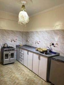 a kitchen with a stove and a chandelier at Appartement of Habiba in Essaouira