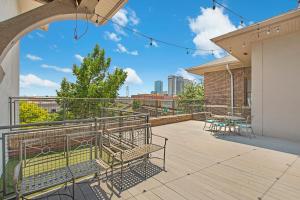 a balcony with benches and tables on a building at Charming 2 bedroom Downtown Ft Worth in Fort Worth
