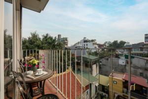a balcony with a table and a view of a city at Hanoian Central Hotel & Spa in Hanoi